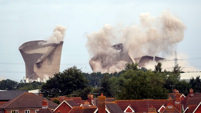 The cooling towers at the disused coal-fired Didcot power station in Oxfordshire, England are demolished Sunday, August 18, 2019.