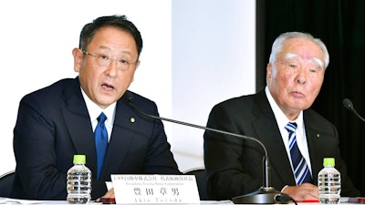 In this Oct. 12, 2016 file photo, Toyota Motor Corp. President Akio Toyoda, left, speaks with Suzuki Motor Corp. Chairman Osamu Suzuki during a news conference in Tokyo. Japan's top automaker, Toyota, and smaller rival Suzuki announced Wednesday, Aug. 28, 2019, they are partnering in the development of self-driving car technology, as manufacturers around the world grapple with innovations in the industry.