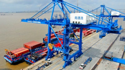 In this July 18, 2019, file photo, shipping containers are loaded onto a cargo ship at a port in Nantong in eastern China's Jiangsu province. Beijing appealed to Washington on Wednesday, Aug. 21, to 'meet China halfway' and end a tariff war after President Donald Trump said Americans might need to endure economic pain to achieve longer-term benefits.