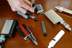 In this Tuesday, April 10, 2018 photo, a high school principal displays vaping devices that were confiscated from students at the school in Massachusetts. On Wednesday, Aug. 14, 2019, the Vapor Technology Association filed a lawsuit against the U.S. government to delay a review of electronic cigarettes.