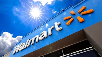 This June 25, 2019, file photo shows the entrance to a Walmart in Pittsburgh. A lawsuit filed earlier this week by Walmart over fires in rooftop solar panels made by Tesla Inc. has been sealed by the court, and both sides say they look forward to addressing all issues. In joint statements Friday, Aug. 23, the companies say they look forward to re-activating the panels once both sides are certain that all concerns have been addressed.