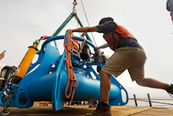 Jeff Pietro, a senior engineer assistant for Woods Hole Oceanographic Institute in Massachusetts, helps move the anchoring system for a microphone, at it is being lowered over the side of the ship in the Santa Barbara Channel off Southern California.