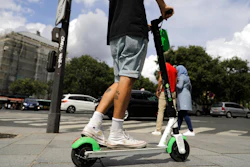 A man rides an electric scooter in Paris, Monday, Aug. 12, 2019. The French government is meeting with people who've been injured by electric scooters as it readies restrictions on vehicles that are transforming the Paris cityscape. The Transport Ministry says Monday's closed-door meeting is part of consultations aimed at limiting scooter speeds and where users can ride and park them.
