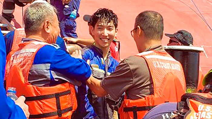 In this image released by the U.S. Coast Guard shows a crew member of the cargo ship Golden Ray as he is helped off the capsized ship Monday, Sept. 9, 2019 off St. Simons Island, Ga. A fire broke out aboard the ship early Sunday, listing it to the side and blocking the shipping channel.