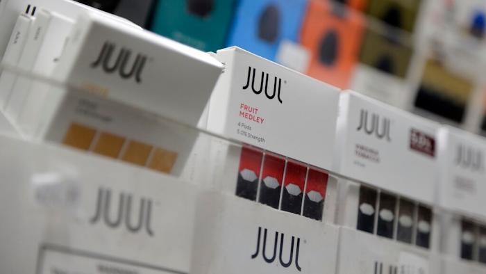 In this Dec. 20, 2018, file photo Juul products are displayed at a smoke shop in New York. Federal health authorities say vaping giant Juul Labs illegally promoted its electronic cigarettes as a safer option to smoking, including in a presentation to school children. The Food and Drug Administration issued a stern warning letter to the company Monday, Sept. 9, 2019, flagging various claims by Juul, including that its products are “much safer than cigarettes.” The FDA has been investigating Juul for months but had not previously warned the company.