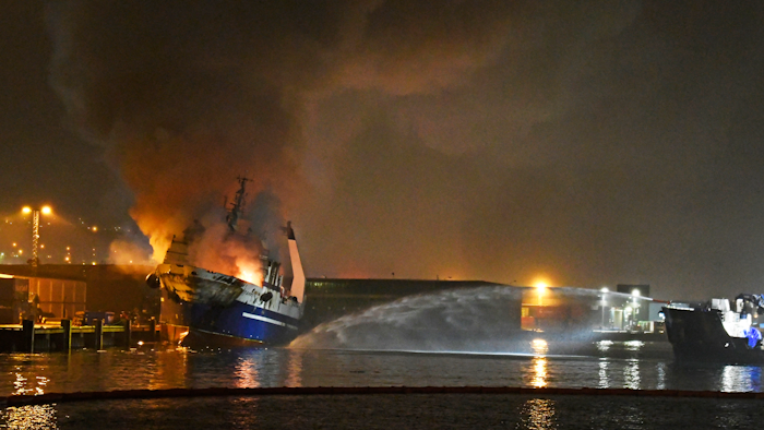 A Russian trawler with an ammonia tank and some 200,000 liters of diesel oil inside is in flames at a northern Norwegian port and authorities have evacuated surrounding areas due to an explosion risk.