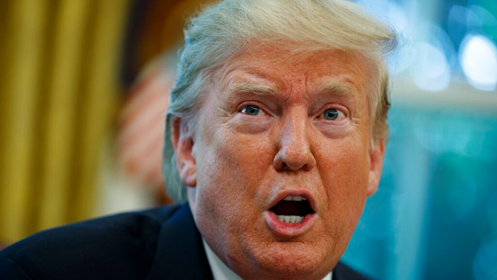 President Donald Trump talks with reporters after receiving a briefing on Hurricane Dorian in the Oval Office of the White House, Wednesday, Sept. 4, 2019, in Washington.