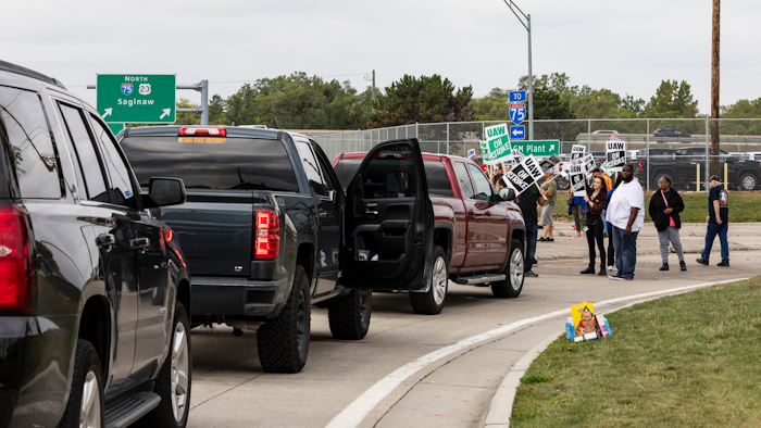 Protesting union members prevent cars from driving into the General Motors Flint Assembly Plant on Bristol Road as United Automobile Workers remain on strike against GM.