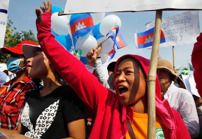 In this May 1, 2015, file photo, garment workers shout slogans during a gathering to mark May Day celebrations in Phnom Penh, Cambodia. Cambodia's government announced Friday it is raising the minimum wage for the garment industry, the country's biggest export earner, whose workers make up a powerful political bloc.