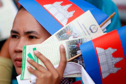 In this May 1, 2018, file photo, a worker participates during a gathering to mark May Day at Tonle Sap river bank, in Phnom Penh, Cambodia. Cambodia's government announced Friday it is raising the minimum wage for the garment industry, the country's biggest export earner, whose workers make up a powerful political bloc.