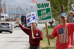 Bob Pevec, right, a 20-year GM employee, pickets outside the General Motors Fabrication Division, Monday, Sept. 23, 2019, in Parma, Ohio. Pevec is a tool and die maker. The strike against General Motors by 49,000 United Auto Workers entered its second week Monday with progress reported in negotiations but no clear end in sight.