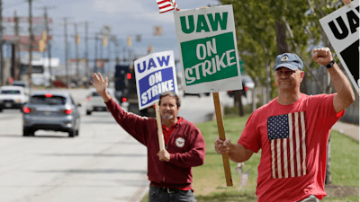 Bob Pevec, right, a 20-year GM employee, pickets outside the General Motors Fabrication Division, Monday, Sept. 23, 2019, in Parma, Ohio. Pevec is a tool and die maker. The strike against General Motors by 49,000 United Auto Workers entered its second week Monday with progress reported in negotiations but no clear end in sight.