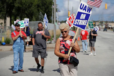 Mara Paulic, a 42-year GM employee, pickets outside the General Motors Fabrication Division, Monday, Sept. 23, 2019, in Parma, Ohio. The strike against General Motors by 49,000 United Auto Workers entered its second week Monday with progress reported in negotiations but no clear end in sight.