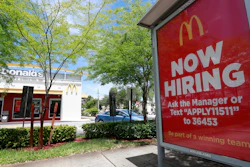 In this Monday, July 1, 2019, file photo, a 'Now Hiring' sign appears on a bus stop in front of a McDonald's restaurant in Miami. Starting Wednesday, Sept. 25, 2019, McDonald’s Corp. will let job seekers start an application by using voice commands on their smartphones with Amazon’s Alexa or Google’s Assistant.