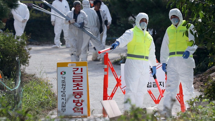 Quarantine officials control access to a pig farm with confirmed African swine fever in Ganghwa, South Korea, Wednesday, Sept. 25, 2019. South Korean on Wednesday said it was intensifying efforts to clean farms around the country as it scrambles to contain the spread of the highly contagious African swine fever that has ravaged farms near its border with North Korea. The notice reads: 'Under quarantine.'