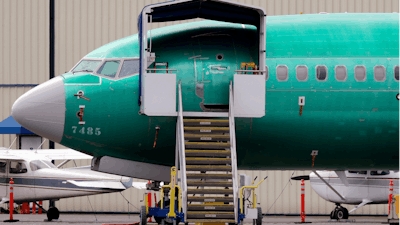 In this April 8, 2019, file photo a Boeing 737 MAX 7 jet is parked near single engine planes at the airport adjacent to a Boeing Co. production facility in Renton, WA.