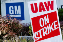 In this Sept. 23, 2019, file photo a sign is posted during a demonstration outside a General Motors facility in Langhorne, PA.