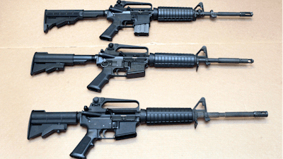 In this file photo, three variations of the AR-15 rifle are displayed.