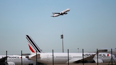 This April 11, 2018 photo shows Air France planes parked on the tarmac at Paris Charles de Gaulle airport, in Roissy, near Paris. A French association of victims says investigating magistrates dropped the case against Air France and Airbus in the 2009 crash of a flight from Rio de Janeiro to Paris that killed all 228 people aboard.