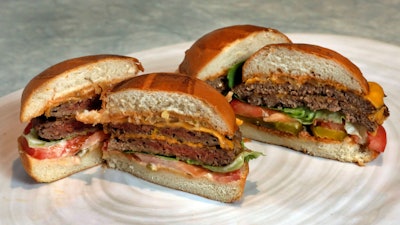 This file photo shows an Original Impossible Burger, left, and a Cali Burger, from Umami Burger, in New York.