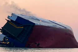 Coast Guard crews and port partners respond to an overturned cargo vessel with a fire on board Sunday, Sept. 8, 2019, in St. Simons Sound, Ga.