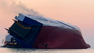 Coast Guard crews and port partners respond to an overturned cargo vessel with a fire on board Sunday, Sept. 8, 2019, in St. Simons Sound, Ga.