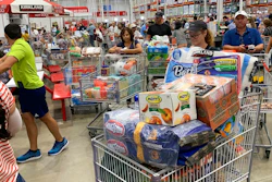 In this Aug. 29, 2019, photo shoppers wait in long lines at Costco in Davie, Fla. On Thursday, Sept. 12, the Labor Department reports on U.S. consumer prices for August.