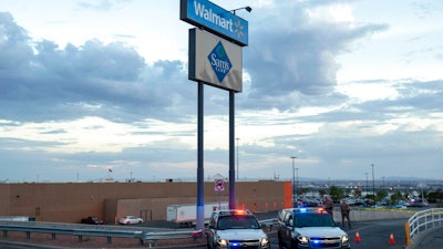 In this Aug. 3, 2019, photo texas state police cars block the access to the Walmart store in the aftermath of a mass shooting in El Paso, Texas. The Bentonville, Arkansas-based discounter says Tuesday, Sept. 3, that it will be discontinuing the sale of short-barrel and handgun ammunition.