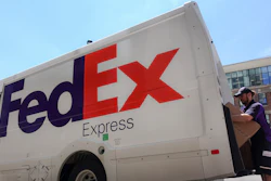 In this file photo a FedEx delivery truck is loaded by an employee on the street in downtown Cincinnati.