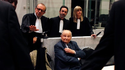 In this May 21, 2013 file photo, Jacques Servier, founder of Servier Laboratories, sits during the opening of the trial of the so-called Mediator case, a drug linked to hundreds of deaths, at Nanterre's court house, outside Paris. A massive trial with more than 4,000 plaintiffs is opening for French pharmaceutical giant Servier Laboratoires and France's medicines watchdog, accused of involuntary manslaughter, fraud and other charges in a scandal over a diabetes medication suspected of causing hundreds of deaths.