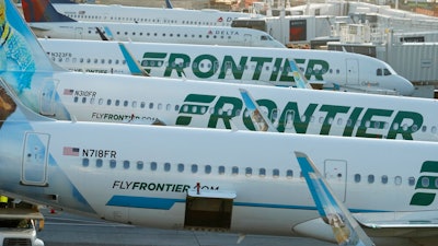 In this June 26, 2019 photo Frontier Airlines jetliners sit at gates on the A concourse at Denver International Airport in Denver. A new report says U.S. airlines are increasing their emissions of climate-changing gases much faster than they are boosting fuel efficiency. The International Council on Clean Transportation said Thursday, Sept. 12, 2019 that carbon dioxide emissions and fuel burning rose 7% from 2016 to 2018, overshadowing a 3% gain in fuel efficiency. The report ranked Frontier the most efficient among the 11 largest U.S. airlines. The Denver-based carrier has added more than 40 Airbus jets with more efficient engines.