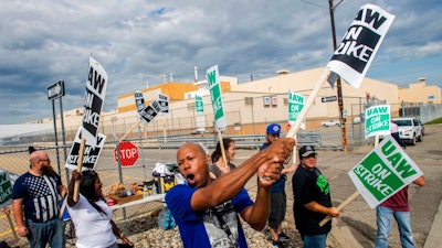 Flint resident Jashanti Walker, who has been a first shift team leader in the body shop for two years, demonstrates with more than a dozen other General Motors employees outside of the Flint Assembly Plant on Sunday, Sept. 15, 2019, in Flint, Mich. The United Auto Workers union says its contract negotiations with GM have broken down.