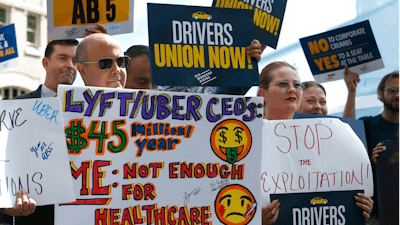 Dozens of supporters of a measure to limit when companies can label workers as independent contractors rally at the Capitol in Sacramento, Calif., Wednesday, Aug. 28, 2019. If approved by the legislature and signed by Gov. Gavin Newsom, AB5, by Assemblywoman Lorena Gonzalez, D-San Diego, would require companies like Uber and Lyft to treat their drivers like employees.