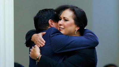 Assemblywoman Lorena Gonzalez, D-San Diego, receives congratulations from Assembly Speaker Anthony Rendon, of Lakewood after her to give new wage and benefit protections at the so-called gig economy companies like Uber and Lyft was approved by the Assembly in Sacramento, Calif., Wednesday, Sept. 11, 2019. The bill now goes to the governor, who has said he supports it.