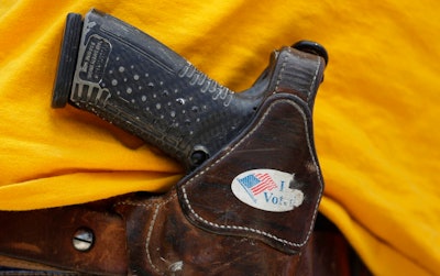 In this April 14, 2018 file photo, a man wears an unloaded pistol during a pro gun-rights rally in Austin, Texas. In a letter sent to the Senate on Thursday, Sept. 12, 2019, CEOs from businesses including Airbnb, Twitter and Uber asked Congress to pass a bill to require background checks on all gun sales and a strong red flag law that would allow courts to issue life-saving extreme risk protection orders.