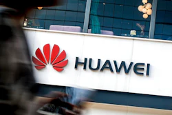 In this July 30, 2019, file photo a woman walks by a Huawei retail store in Beijing. Chinese tech giant Huawei has accused U.S. authorities of trying to coerce employees to gather information on the company and of trying to break into its information systems. The company, the target of U.S. accusations that it is a security threat, said Wednesday, Sept. 4, that American officials were using 'unscrupulous means' to disrupt its business.