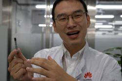 In this Aug. 21, 2019, photo, a Huawei research engineer holds up a coated screw designed to reduce signal interference at the Huawei Materials lab in Dongguan in Southern China's Guangdong province. Facing a ban on access to U.S. technology, Chinese telecom equipment maker Huawei is showing it increasingly can do without American components and compete with Western industry leaders in pioneering research.