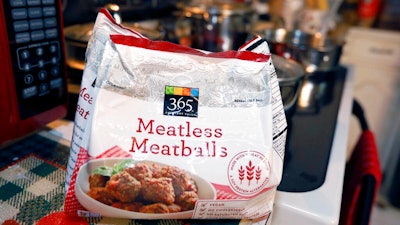 This July 2, 2019, file photo shows a bag of 'meatless meatballs'. Mississippi is considering new rules that let companies continue to use food-labeling terms such as “veggie burger” and “vegan bacon,” as long as the terms are prominently displayed so consumers understand the products are not meat. The state agriculture department on Thursday, Sept. 5, 2019, proposed new regulations for plant-based products that are sold as alternatives to meat. The regulations came in response to a lawsuit filed by a nonprofit organization advocating plant-based foods and an Illinois food company. The lawsuit was filed on July 1, the same day the state enacted a law dictating that 'a plant-based or insect-based food product shall not be labeled as meat or a meat food product.'