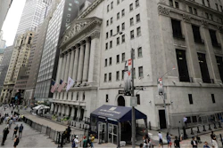In this file photo pedestrians pass the New York Stock Exchange in New York.