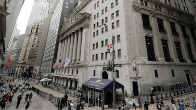 In this file photo pedestrians pass the New York Stock Exchange in New York.