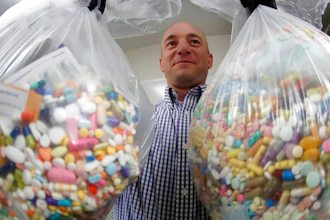 Narcotics detective Ben Hill, with the Barberton Police Department, shows two bags of medications that are are stored in their headquarters and slated for destruction, Wednesday, Sept. 11, 2019, in Barberton, Ohio. Attorneys representing some 2,000 local governments said Wednesday they have agreed to a tentative settlement with OxyContin maker Purdue Pharma over the toll of the nation's opioid crisis.