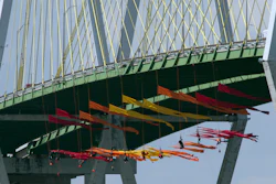Greenpeace USA protesters dangle from the Fred Hartman Bridge Thursday, September 12, 2019, in Baytown, Texas. A portion of the Houston Ship Channel has closed after about a dozen Greenpeace USA activists protesting the use of fossil fuels suspended themselves from a bridge ahead of a Democratic presidential debate.