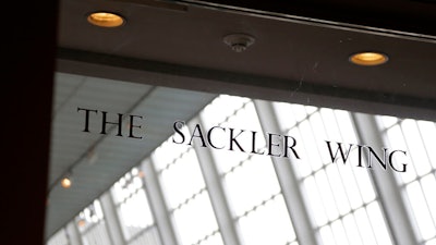 In this Jan. 17, 2019, file photo, a sign with the Sackler name is displayed at the Metropolitan Museum of Art in New York. Their name used to be on a wing at the Louvre. But now the Sackler family wealth has become linked to sales of OxyContin, and their company, drug maker Purdue Pharma, is attempting to settle lawsuits over the opioid crisis.