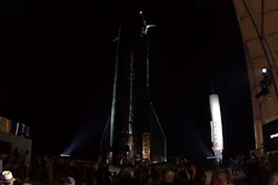 In this image made from video provided by SpaceX, Elon Musk, center, speaks of SpaceX's newly designed aircraft at its launch facility near Brownsville, Texas, Saturday, Sept. 28, 2019. Musk unveiled Saturday the SpaceX spacecraft designed to carry a crew and cargo to the moon, Mars or anywhere else in the solar system and land back on Earth perpendicularly.