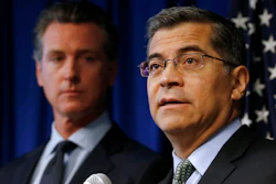 In this Sept. 18, 2019 file photo California Attorney General Xavier Becerra, right, flanked by Gov. Gavin Newsom, discusses the Trump administration's pledge to revoke California's authority to set vehicle emissions standards that are different than the federal standards, during a news conference in Sacramento, Calif. Twenty-three states have sued to stop the Trump administration from revoking California's authority to set emission standards for cars and trucks. Becerra is leading the lawsuit filed Friday, Sept. 20 along with Newsom and the California Air Resources Board.