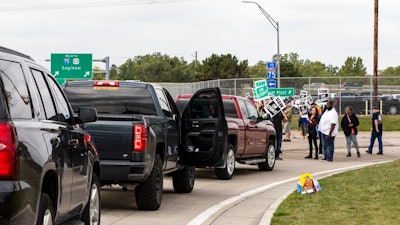 Protesting union members prevent cars from driving into the General Motors Flint Assembly Plant on Bristol Road as United Automobile Workers remain on strike against GM on Tuesday, Sept. 17, 2019, in Flint, Mich. GM and the union are faced with weakening vehicle sales, a deteriorating global economy and an unpredictable trade war.