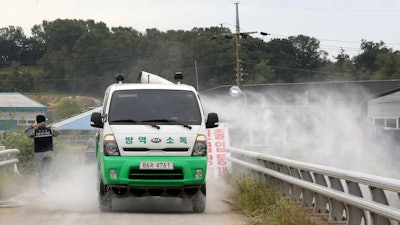 Disinfectant solution is sprayed from a vehicle as a precaution against African swine fever near a pig farm in Paju, South Korea.