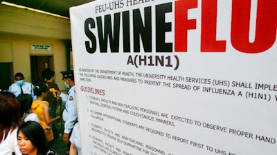 In this June 19, 2009, file photo, a large billboard is displayed at the entrance of a university as security guards use a thermal scanner to check on students temperature before allowing them to enter the school premise in Manila, Philippines. On Monday, Sept. 9, 2019, Philippine officials say lab tests have confirmed African swine fever caused the deaths of pig herds in at least seven villages and a multi-agency force will be set up to try to contain the contagious disease.