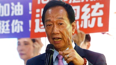 In this June 21, 2019, file photo, Terry Gou, chairman of Foxconn, the world's largest contract assembler of consumer electronics, speaks to the media after the company's annual shareholders meeting in New Taipei City, Taiwan.