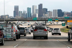 In this Thursday, July 11, 2019, file photograph, southbound Interstate 25 traffic lanes bog down to a crawl at the interchange with Interstate 70 just north of downtown Denver. On Friday, Sept. 6, 2019, the U.S. Environmental Protection Agency held a hearing to decide whether to lower the ozone status of Denver and eight other northern Colorado counties from 'moderate' to 'serious,' a move that would force the state to take action to clean the air but which businesses have voiced objections over meeting any possible regulatory changes.